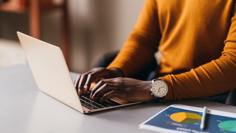 Focused African American woman typing on laptop, business concept