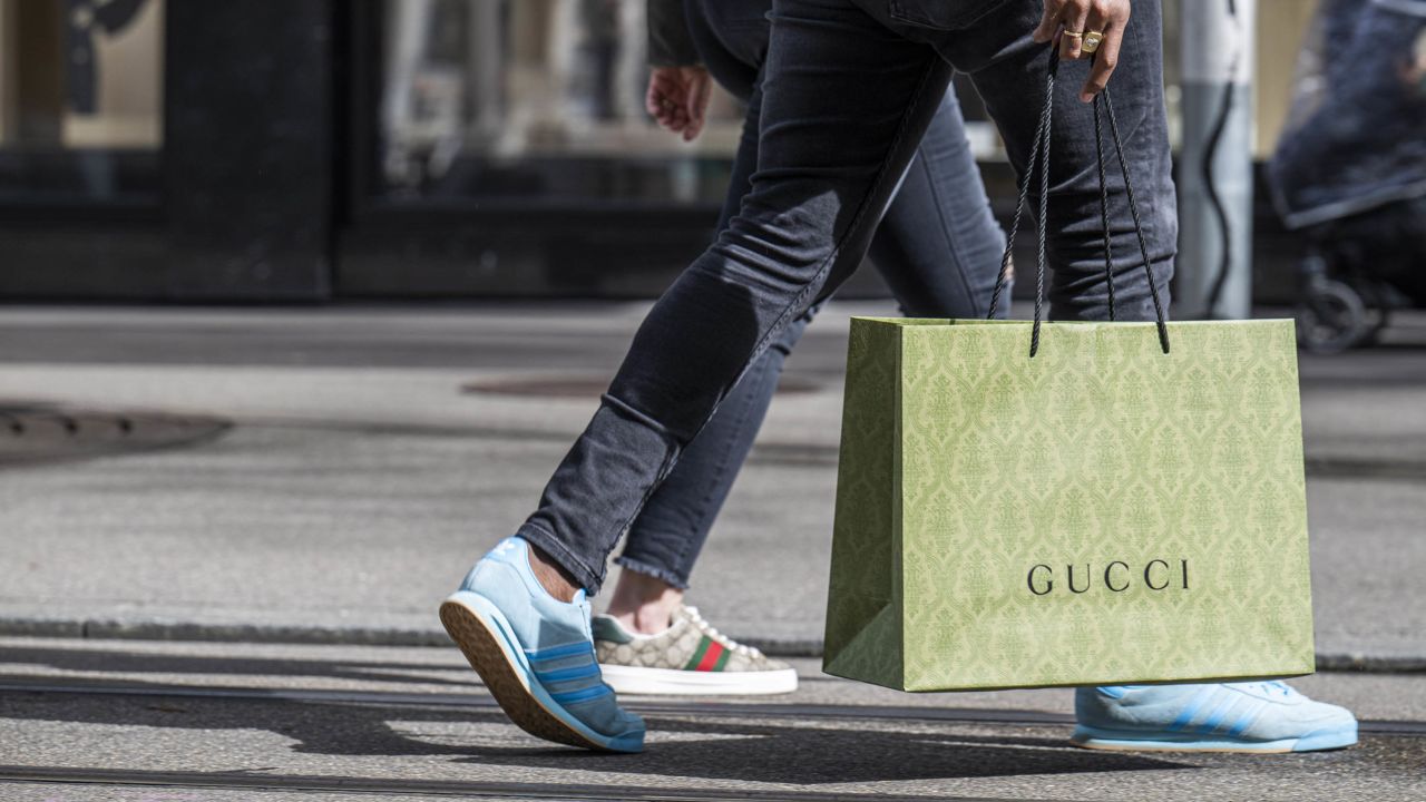 A shopper carries a Gucci shopping bag in central Zurich, Switzerland, on Saturday, March 16, 2024. The Swiss National Bank will announce interest rates on March 21. Photographer: Pascal Mora/Bloomberg via Getty Images