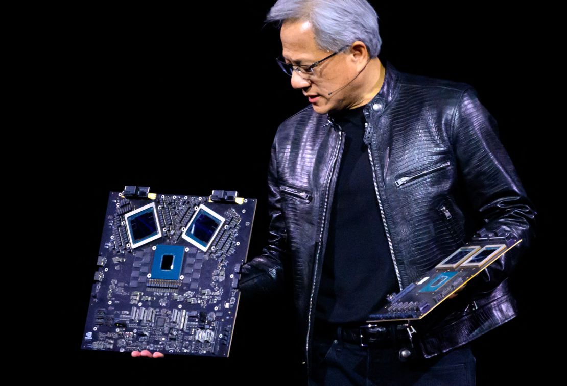 NVIDIA's CEO Jensen Huang displays products on stage at the SAP Center in San Jose, California, on March 18.