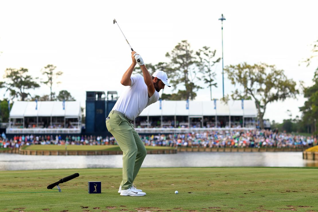 Two-time Players Championship winner Scottie Scheffler plays a shot onto the island green.