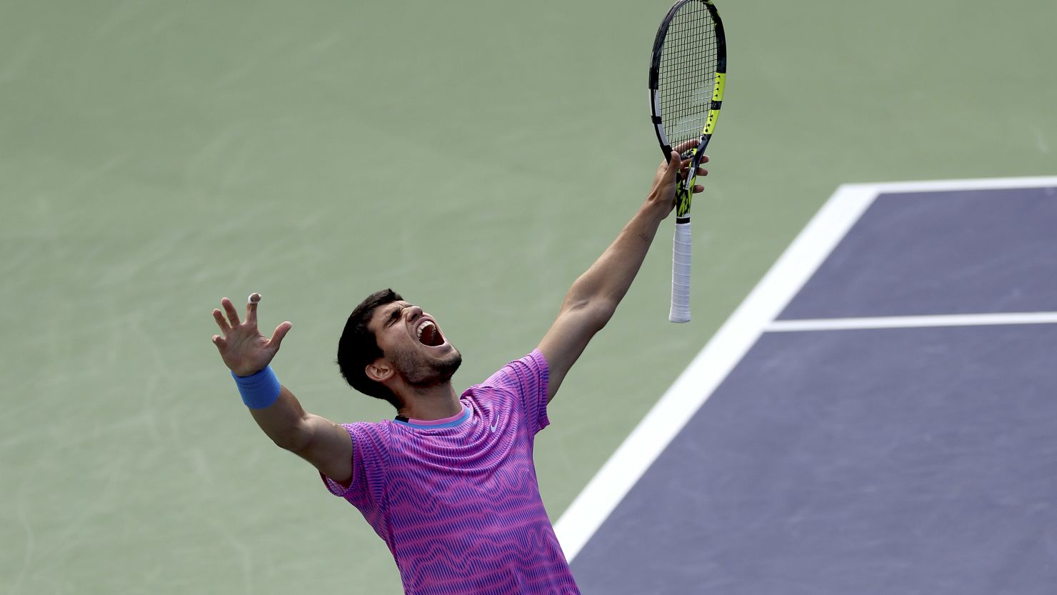 Alcaraz celebrates winning match point against Medvedev at Indian Wells in California.