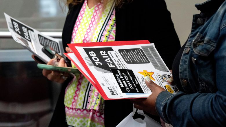 Jobseekers hold flyers during a career fair at a NC Works Career Center in Wilmington, North Carolina, on Wednesday, March 20, 2024.