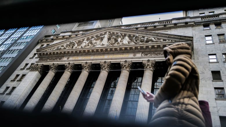 A person walks past the New York Stock Exchange (NYSE) at Wall Street in the Manhattan borough of New York on March 20, 2024.