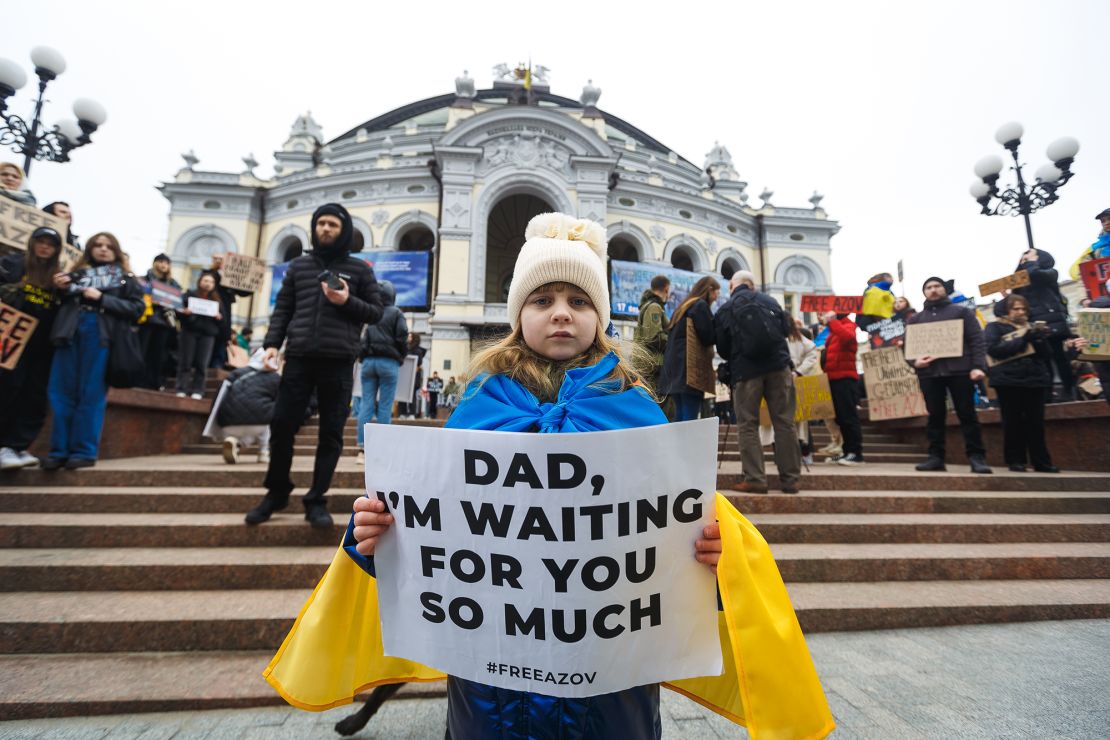 A girl holds a poster during a rally by families of Ukrainian prisoners of war on March 17, 2024 in Kyiv, Ukraine.