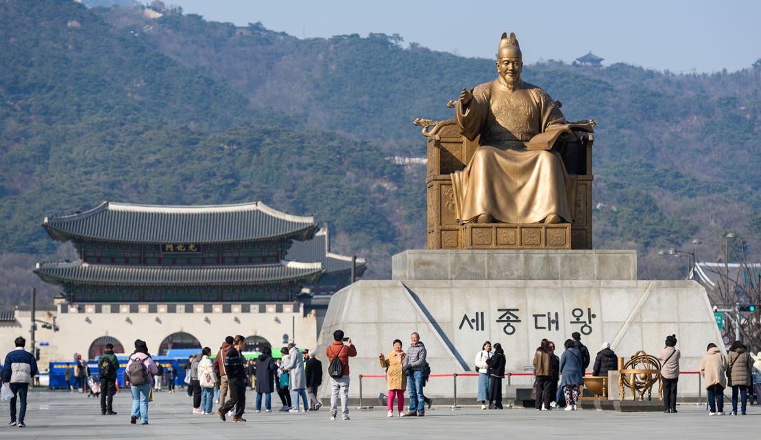 Tourists visit the statue of Sejong the Great of the Joseon Dynasty at Gwanghwamun Square in Seoul, South Korea on February 21, 2024.