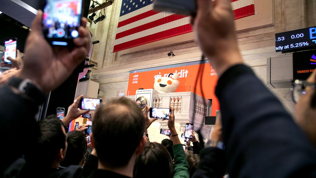 Snoo, mascot of Reddit Inc., rings the opening bell during the company's initial public offering (IPO) on the floor of the New York Stock Exchange (NYSE) in New York, US, on Thursday, March 21, 2024. Reddit Inc. and its selling shareholders raised $748 million, pricing shares in an initial public offering at the top of a marketed range, the second big tech listing in as many days.