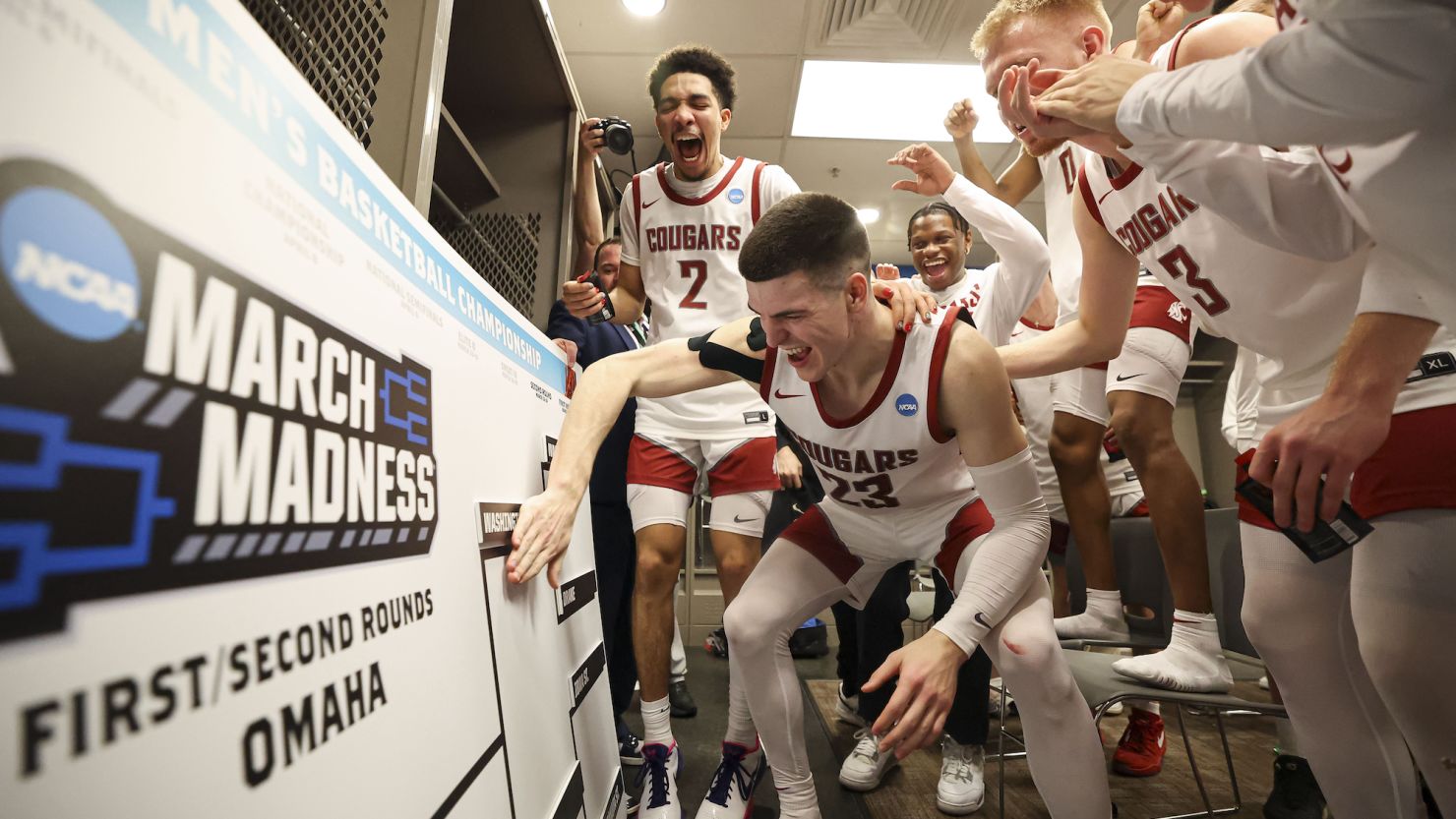 Andrej Jakimovski of the Washington State Cougars moves his team's card into the second-round spot on the March Madness bracket after defeating the Drake Bulldogs in the first round.