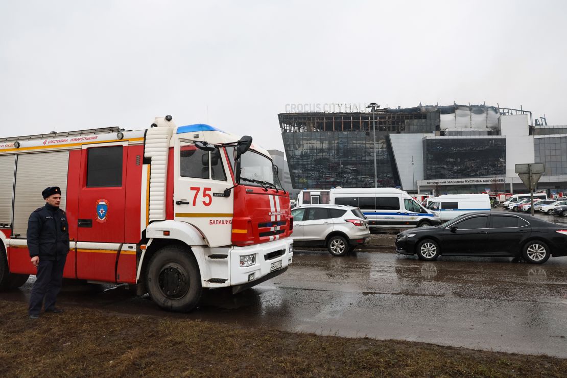 Emergency services personnel and police work at the scene of the Crocus City Hall attack.