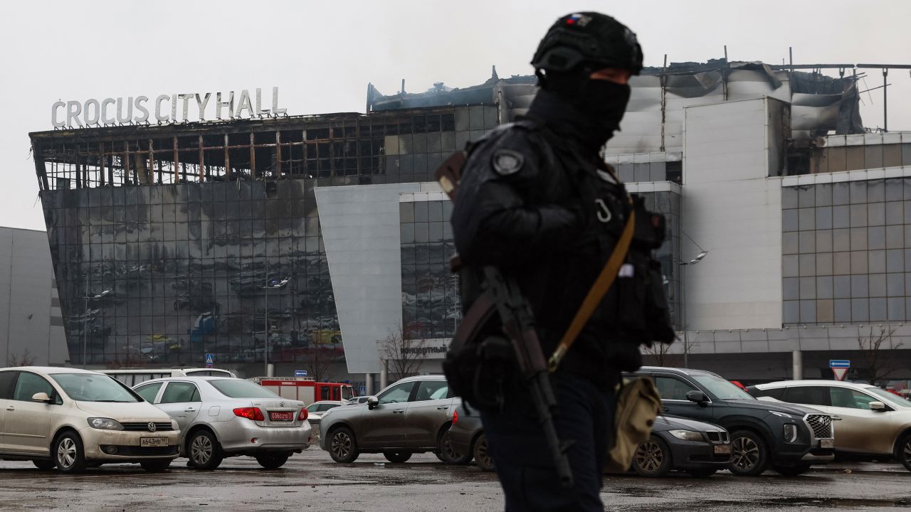 A law enforcement officer patrols the scene of the gun attack at the Crocus City Hall concert hall in Krasnogorsk, outside Moscow, on March 23, 2024. Gunmen who opened fire at a Moscow concert hall killed more than 60 people and wounded over 100 while sparking an inferno, authorities said on March 23, 2024, with the Islamic State group claiming responsibility.