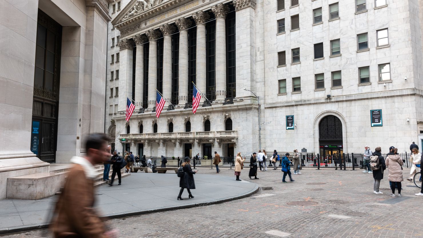 People walk by the New York Stock Exchange (NYSE) on March 20, 2024 in New York City. The Dow was up slightly in late morning trading as traders analyze the Federal Reserve's latest decision on interest rates.