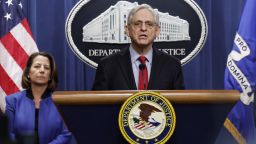 U.S. Attorney General Merrick Garland speaks alongside Deputy Attorney General Lisa Monaco during a news conference at the Department of Justice Building on March 21, 2024 in Washington, DC. During the news conference Garland and DOJ officials announced the department would be taking action against Apple, claiming that the tech company has an illegal monopoly on smartphones, violating antitrust laws.
