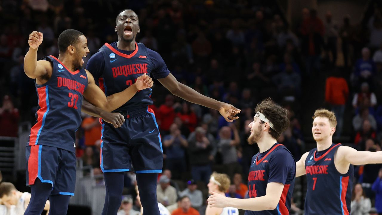 Kareem Rozier #32 and Fousseyni Drame #34 of the Duquesne Dukes react after defeating the Brigham Young Cougars during the second half in the first round of the NCAA Men's Basketball Tournament at CHI Health Center on March 21 in Omaha, Nebraska.