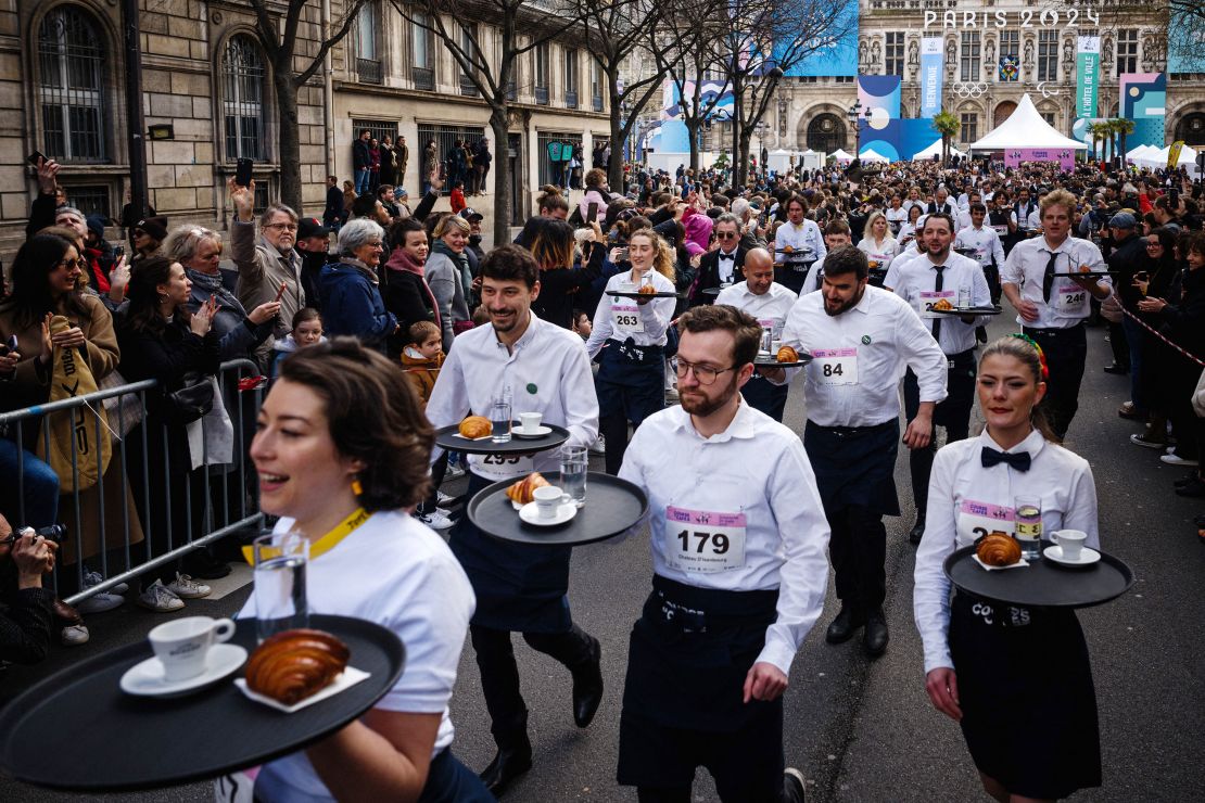 Servers start the Course des Cafés race Sunday in Paris.