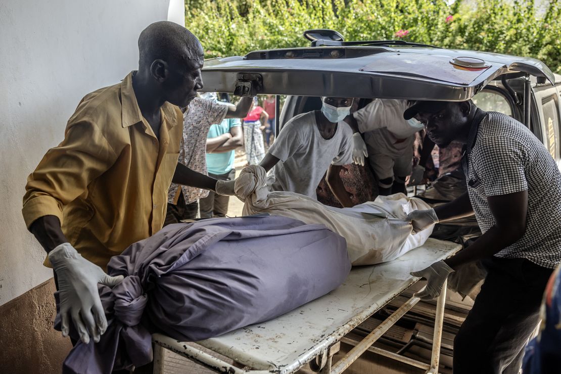 Mortuary workers move the remains of several members of the same family who were victims of the Kenyan starvation cult.