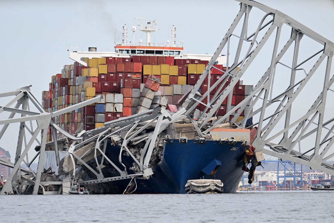 The steel frame of the Francis Scott Key Bridge sits on top of the container ship Dali after the bridge collapsed.