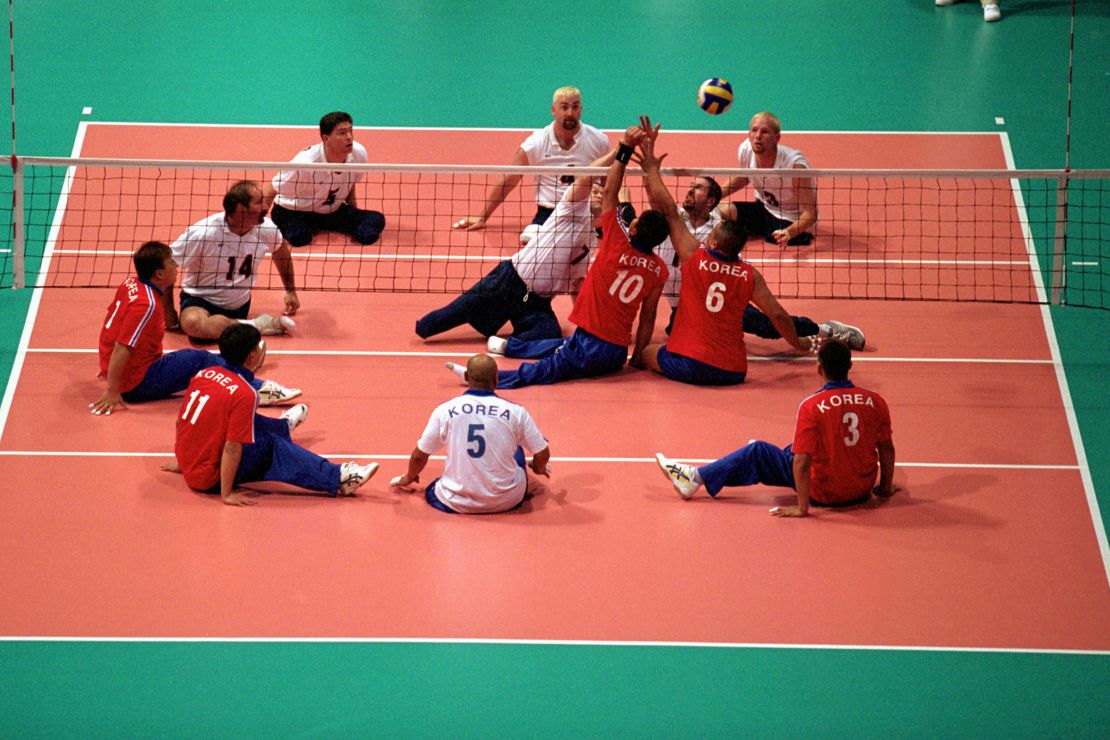 Team USA spikes the ball over the net against Team Korea in the Sydney 2000 Paralympic Games.