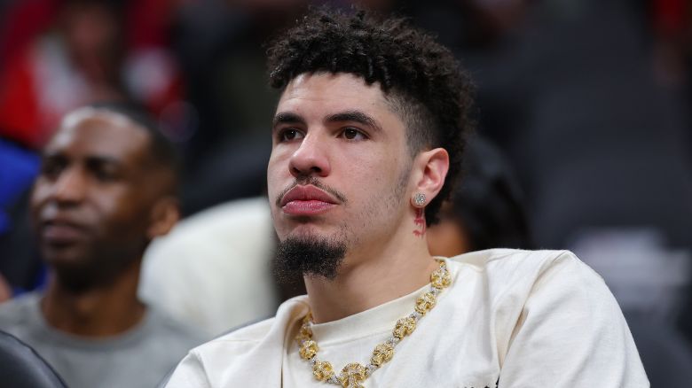 LaMelo Ball looks on from the bench during the first quarter of the Charlotte Hornets' game against the Atlanta Hawks at State Farm Arena on March 23, 2024.