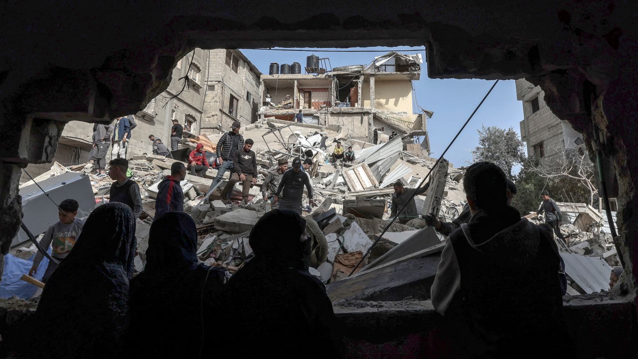 TOPSHOT - Palestinians check the rubble of buildings that were destroyed following overnight Israeli bombardment in Rafah, in the southern Gaza Strip, on March 27, 2024, amid the ongoing conflict between Israel and the Palestinian militant group Hamas. (Photo by MOHAMMED ABED / AFP) (Photo by MOHAMMED ABED/AFP via Getty Images)