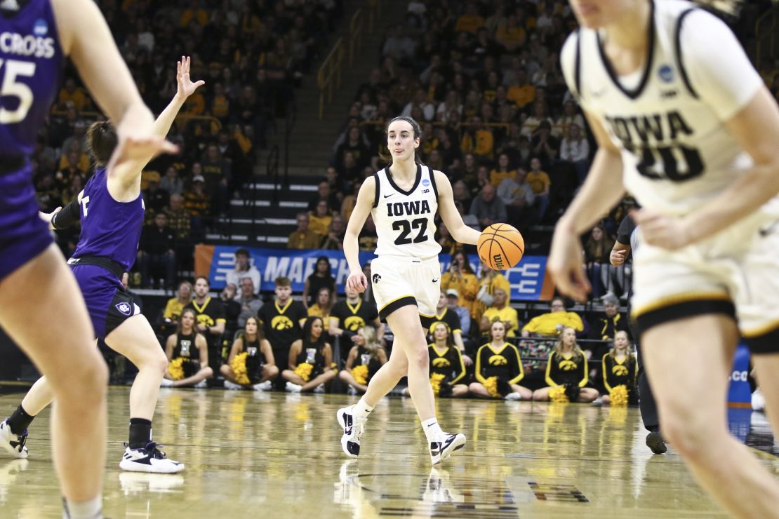 Clark brings the ball down the court during the first half of Iowa's match against the Holy Cross Crusaders at March Madness.
