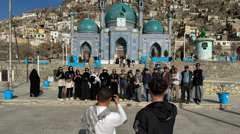 TOPSHOT - In this picture taken on March 25, 2024 Thai tourists pose for a group picture during their visit to the Kart-e-Sakhi Shrine in Kabul. Decades of conflict made tourism extremely rare, and while most violence has now abated visitors are confronted with extreme poverty, dilapidated cultural sites and scant hospitality infrastructure. (Photo by Wakil Kohsar / AFP) / To go with "AFGHANISTAN-TOURISM, REPORTAGE' by Pascale TROUILLAUD (Photo by WAKIL KOHSAR/AFP via Getty Images)