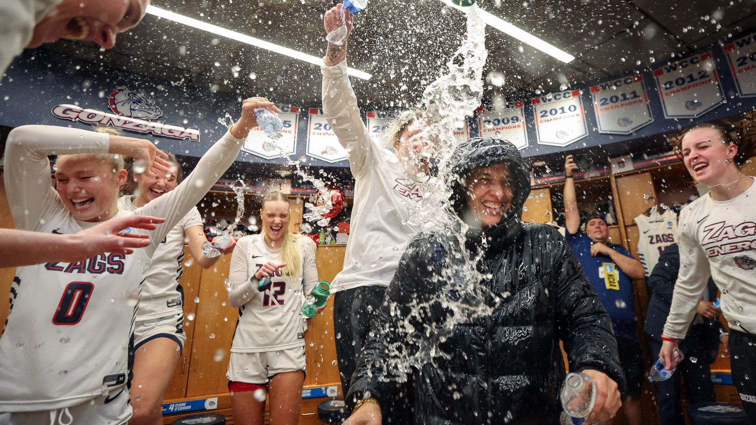 The Gonzaga Bulldogs celebrate in the locker room after beating Utah Utes in the second round of the women's March Madness.