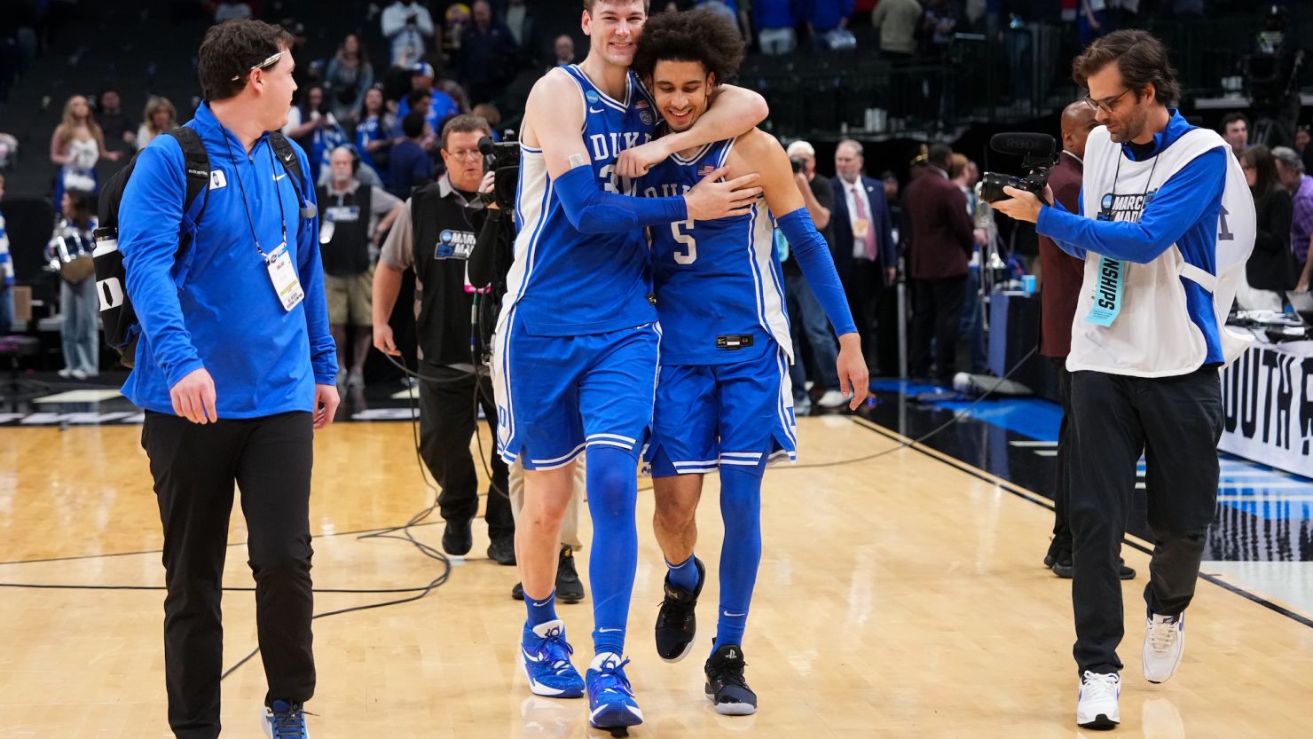 Kyle Filipowski #30 hugs Tyrese Proctor #5 of the Duke Blue Devils after defeating the Houston Cougars during the Sweet Sixteen round of the 2024 NCAA Men's Basketball Tournament held at American Airlines Center on Friday in Dallas, Texas.