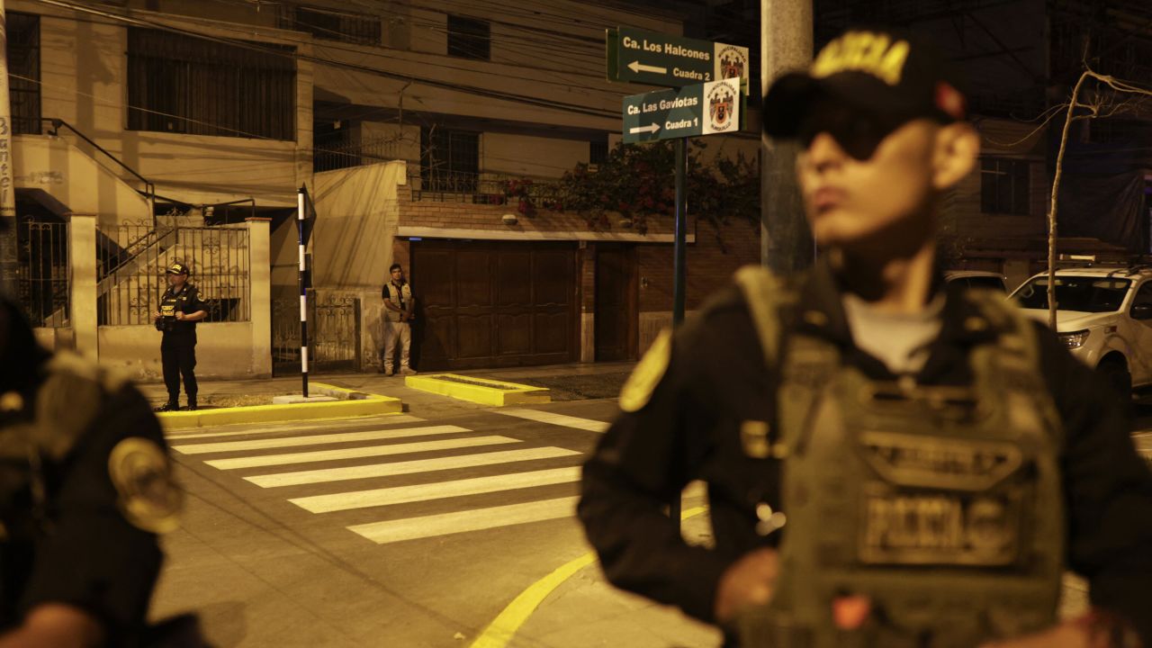 Police guard outside President Dina Boluarte's house during a raid ordered by the Attorney General's Office as part of a preliminary investigation in Lima on March 30, 2024.