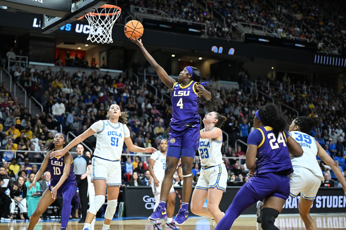 ALBANY, NEW YORK - MARCH 30: Flau'jae Johnson #4 of the LSU Lady Tigers jumps for the basket over Lauren Betts #51 and Gabriela Jaquez #23 of the UCLA Bruins during the Sweet Sixteen round of the 2024 NCAA Women's Basketball Tournament held at MVP Arena on March 30, 2024 in Albany, New York. (Photo by Greg Fiume/NCAA Photos via Getty Images)