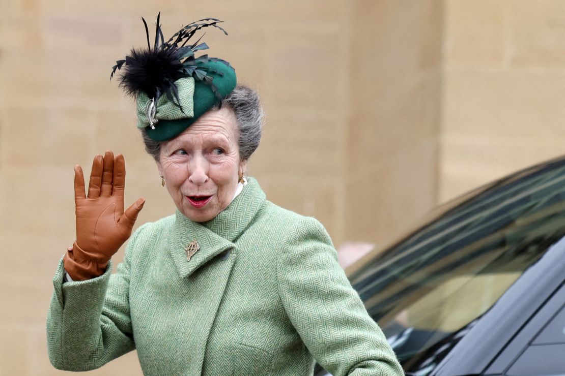 The Princess Royal waves to members of the public as she arrives for the family outing on Sunday. 