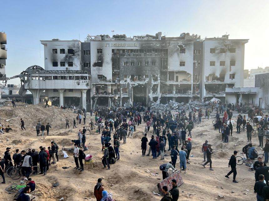 Palestinians gather around the heavily damaged Al-Shifa Hospital, in Gaza City, on April 1, 2024.