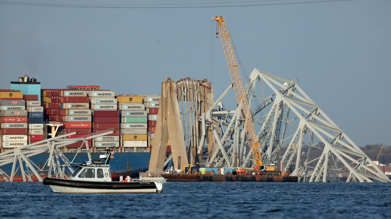 BALTIMORE, MARYLAND - MARCH 29:  A crane works on the debris of the Francis Scott Key Bridge on March 29, 2024 in Baltimore, Maryland. The bridge collapsed on Tuesday at 1:30AM , after being struck by the massive cargo ship Dali. Two members of a road repair crew were pulled from the Patapsco River immediately after the collision, while two other bodies were pulled from the water on Wednesday and four people remain missing and are presumed dead after the Coast Guard called off rescue efforts. The accident has temporarily closed the Port of Baltimore, one of the largest and busiest on the East Coast of the U.S. (Photo by Kevin Dietsch/Getty Images)