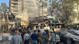 Emergency and security personnel gather at the site of strikes in Syria's capital Damascus, on April 1, 2024.