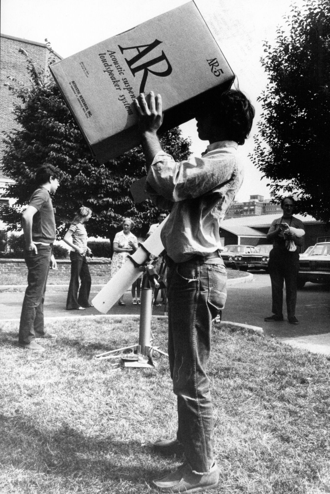 A man views the 1972 total solar eclipse through a cardboard box.