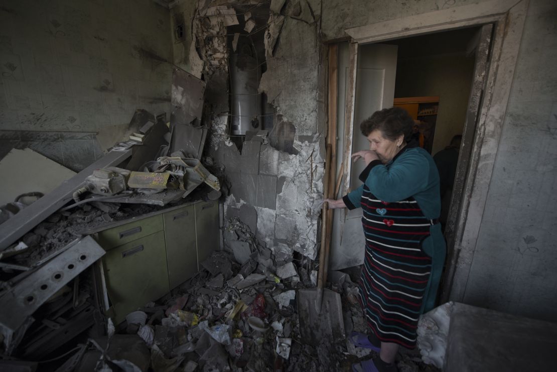 A woman stands among the rubble in her apartment hit by shelling in Donetsk, Russian-controlled Ukraine, on April 2.