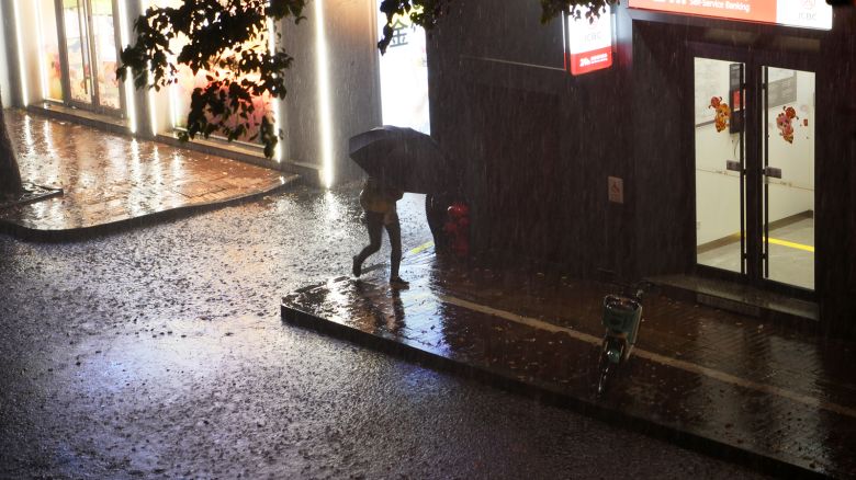 A citizen braves heavy rain on the evening of April 2, 2024 in Nanchang, Jiangxi province, China.