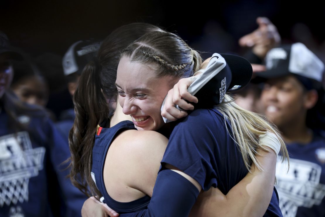 Bueckers and Nika Muhl hug after UConn's victory over USC in the Elite Eight round.