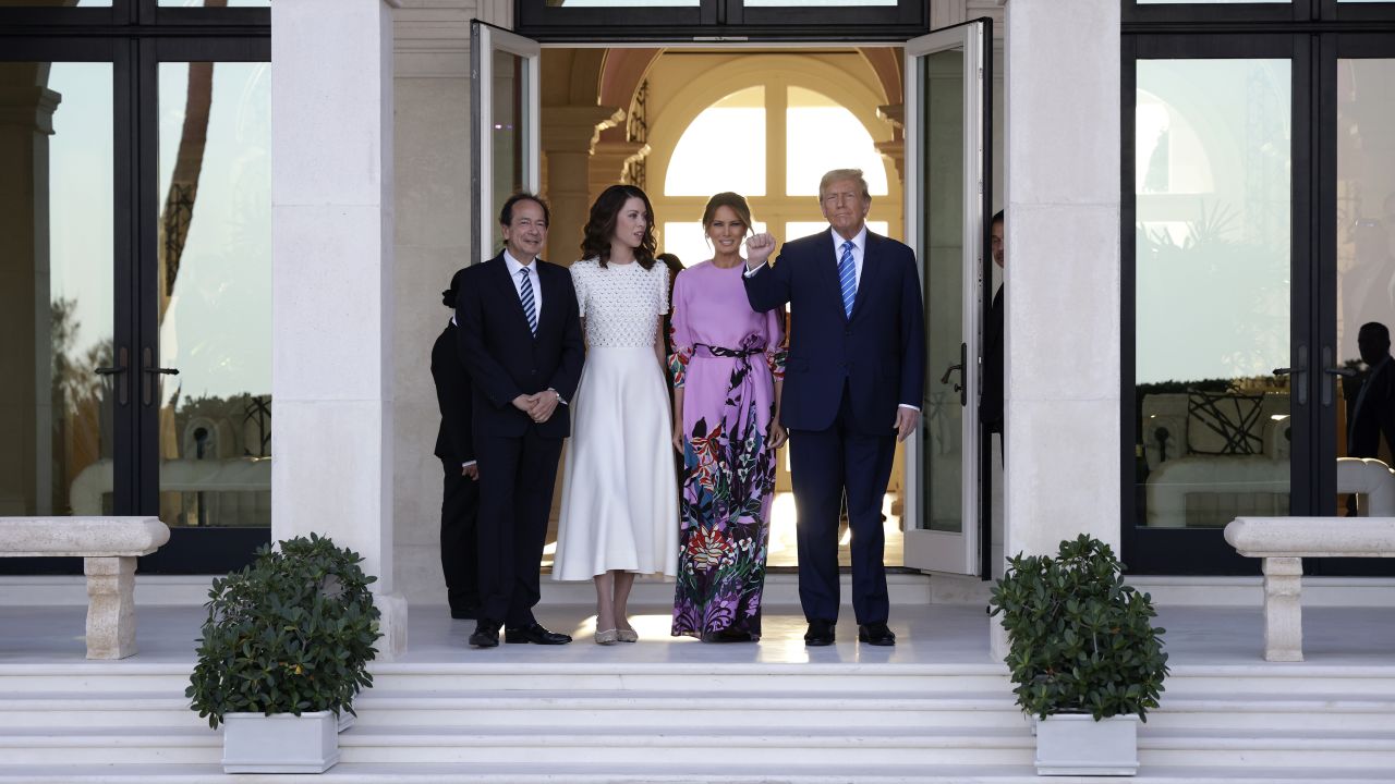 Former President Trump Arrives At A Fundraiser In Palm Beach, Florida. Republican presidential candidate and former US President Donald Trump (R) and former first lady Melania Trump (2nd-R) arrive at the home of John Paulson (L) with Alina de Almeida (2nd-L) on April 6, 2024 in Palm Beach, Florida. Trump's campaign is expecting to raise more than 40 million dollars, when major donors gather for a fundraiser billed as the "Inaugural Leadership Dinner".