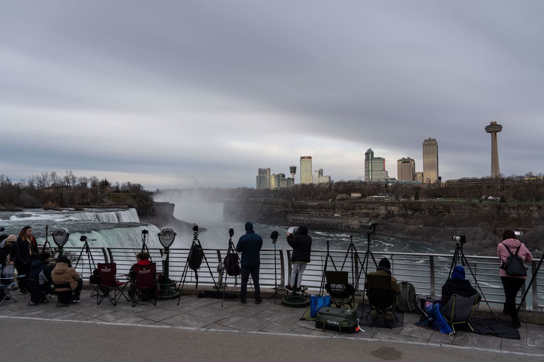  Photographers get in to position early in the morning in preparation for the Solar Eclipse later today on April 8, 2024 in Niagara Falls, New York.