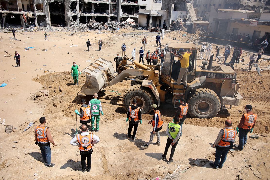 Palestinian forensic and civil defense workers recover bodies at the grounds of Al-Shifa, Gaza's largest hospital, which was reduced to rubble by a two-week Israeli raid, on April 8, 2024.