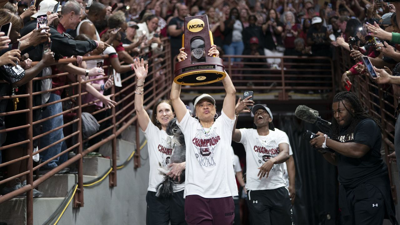 COLUMBIA, SOUTH CAROLINA - APRIL 8:  South Carolina coach Dawn Staley raises the NCAA Women's Basketball Championship trophy at a celebration at the Colonial Life Arena on April 8, 2024 in Columbia, South Carolina. University classes that were scheduled during the event were canceled. The South Carolina Gamecocks defeated the Iowa Hawkeyes 87-75 to cap a perfect season. (Photo by Sean Rayford/Getty Images)