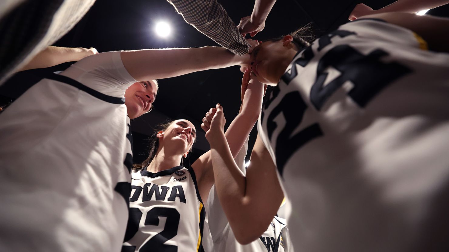 Caitlin Clark of the Iowa Hawkeyes huddles with her team after beating the Connecticut Huskies in Cleveland, Ohio, on April 5.