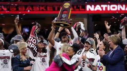 CLEVELAND, OHIO - APRIL 07: The South Carolina Gamecocks celebrate with the trophy after beating the Iowa Hawkeyes in the 2024 NCAA Women's Basketball Tournament National Championship at Rocket Mortgage FieldHouse on April 07, 2024 in Cleveland, Ohio. South Carolina beat Iowa 87-75. (Photo by Steph Chambers/Getty Images)