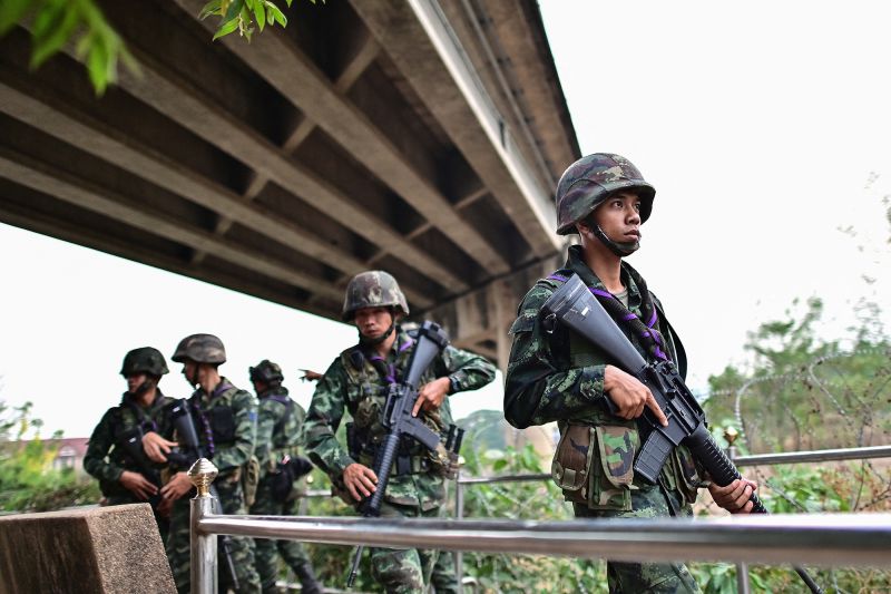 Thai military personnel stand guard overlooking the Moei river on the Thai side, near the Tak border checkpoint with Myanmar, in Thailand's Mae Sot district on April 10, 2024. Thai armoured cars patrolled the town of Mae Sot on April 10 as the deep boom of artillery thundered across from the border in Myanmar where the junta and an ethnic armed group fought for a second day near a vital trade hub. (Photo by MANAN VATSYAYANA / AFP) (Photo by MANAN VATSYAYANA/AFP via Getty Images)