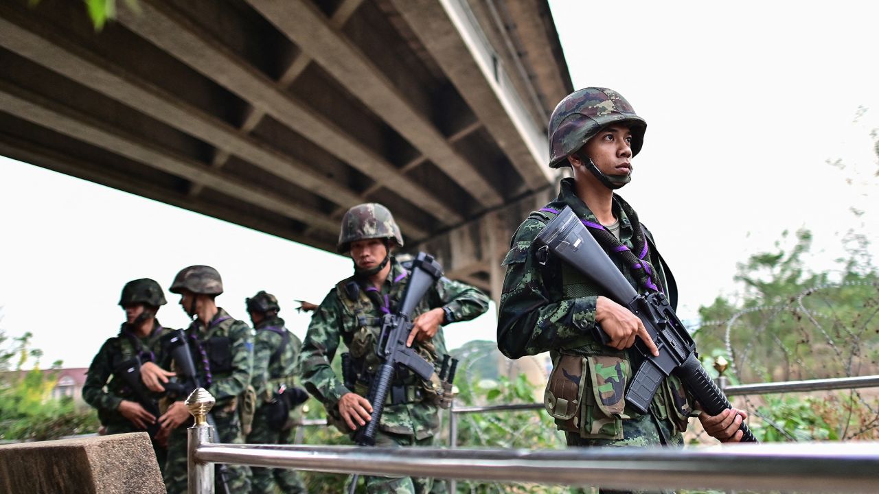 Thai military personnel stand guard overlooking the Moei river on the Thai side, near the Tak border checkpoint with Myanmar, in Thailand's Mae Sot district on April 10, 2024. Thai armoured cars patrolled the town of Mae Sot on April 10 as the deep boom of artillery thundered across from the border in Myanmar where the junta and an ethnic armed group fought for a second day near a vital trade hub. (Photo by MANAN VATSYAYANA / AFP) (Photo by MANAN VATSYAYANA/AFP via Getty Images)