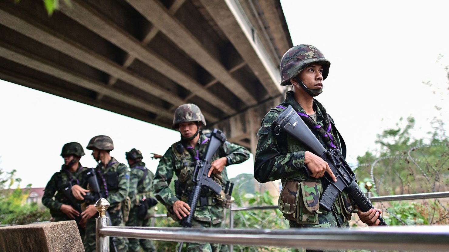 Thai military personnel stand guard overlooking the Moei river on the Thai side, near the Tak border checkpoint with Myanmar, in Thailand's Mae Sot district on April 10, 2024.