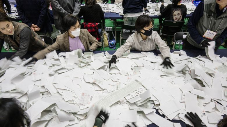 Election officials sort through ballots at a counting station in Seoul on April 10, 2024, after voting in the parliamentary elections was closed. (Photo by ANTHONY WALLACE / AFP) (Photo by ANTHONY WALLACE/AFP via Getty Images)
