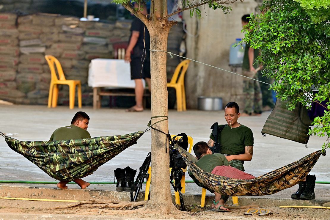 Members of a Myanmar militia are seen across the Moei river on the Myanmar side, as pictured from Thailand's Mae Sot district on April 11, 2024.
