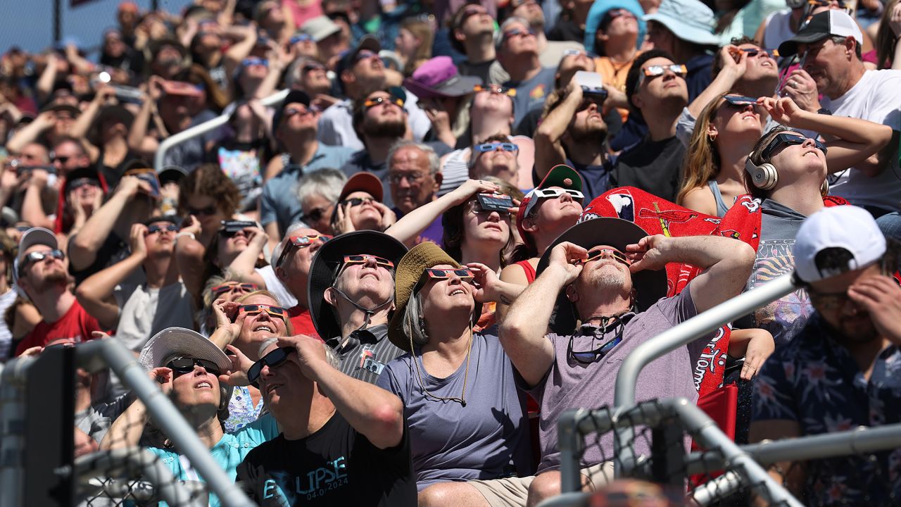 CARBONDALE, ILLINOIS - APRIL 08: People view the start of the total eclipse on the campus of Southern Illinois University on April 08, 2024 in Carbondale, Illinois. People have travelled from around the country to the campus to view the rare celestial phenomenon. Cities around the country that are in the path of totality are experiencing a similar influx of tourists. (Photo by Scott Olson/Getty Images)