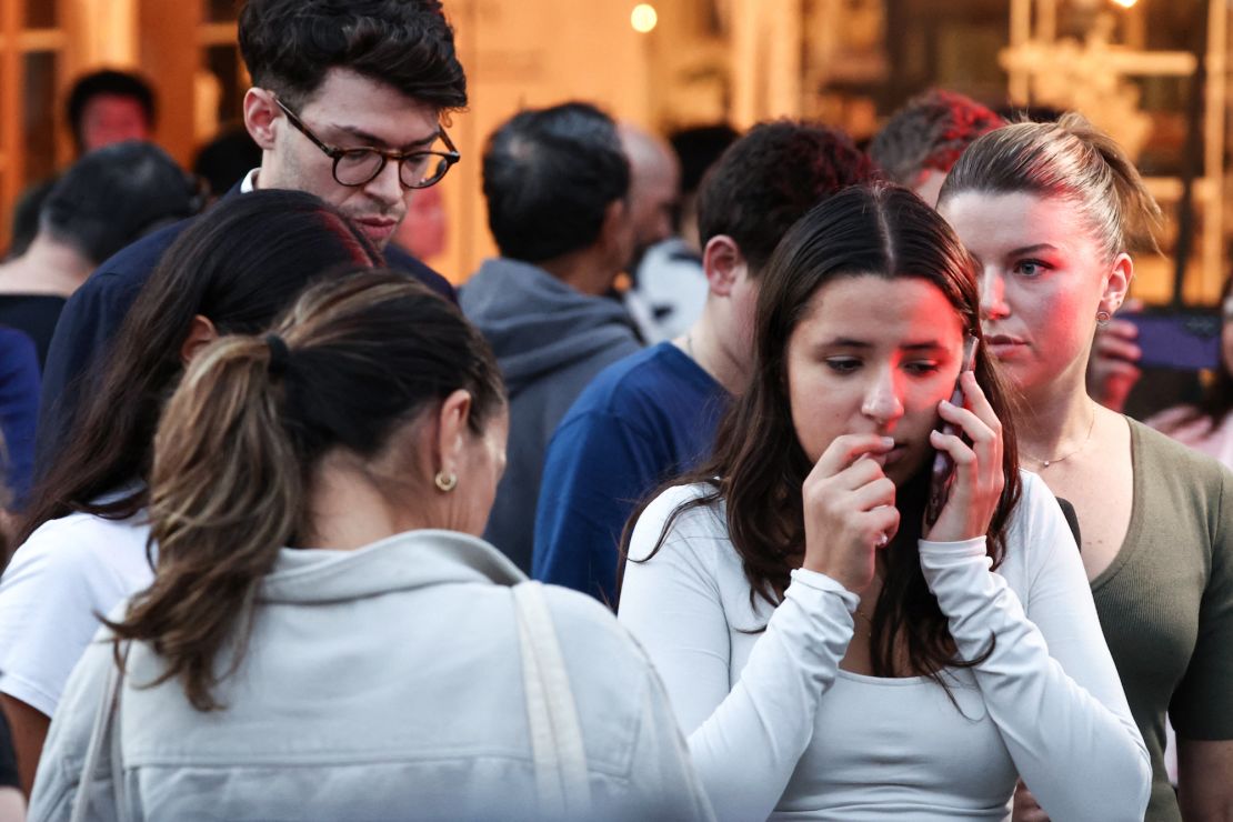 People react outside the Westfield Bondi Junction shopping mall after a stabbing incident in Sydney on April 13, 2024.