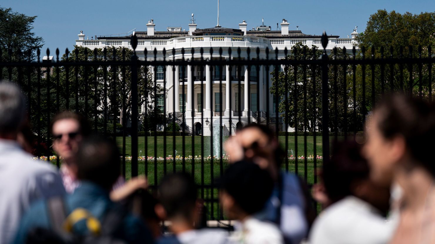 People pass outside of the White House in Washington, DC, on April 14, 2024.